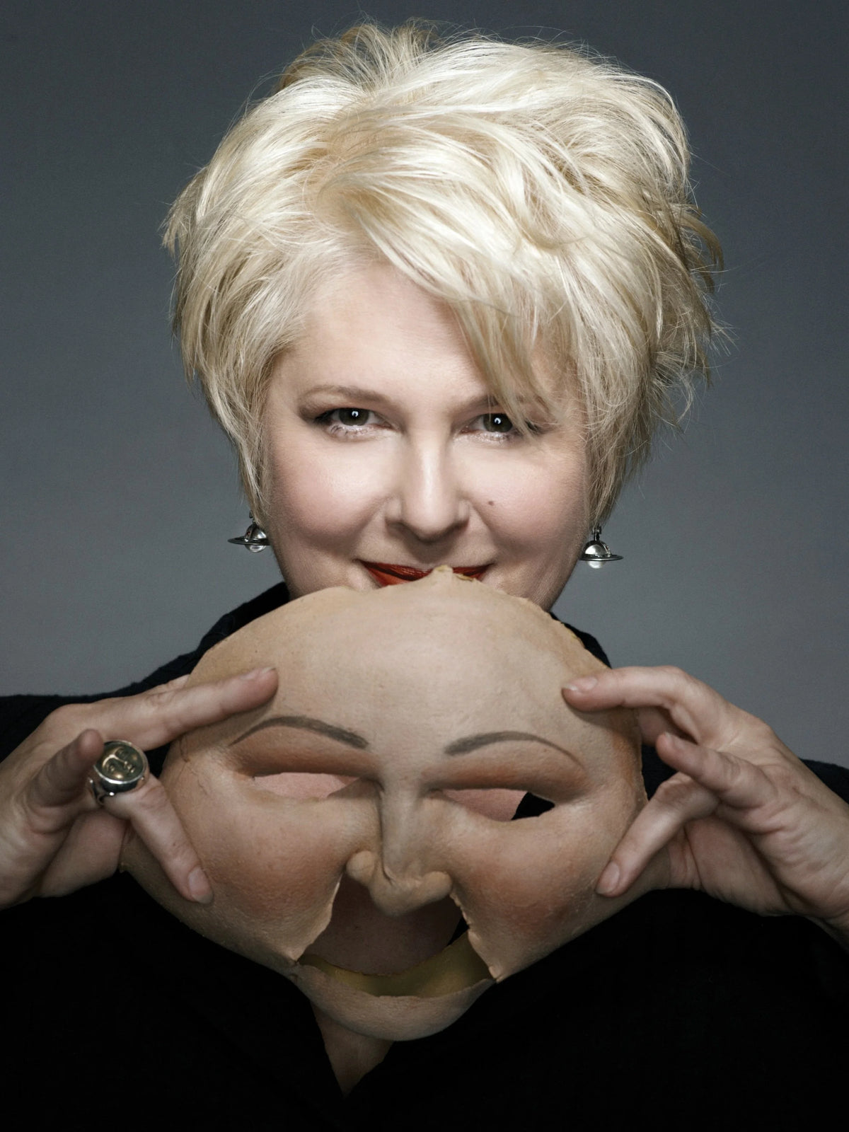 Jennifer Aspinall holding a prosthetic mask.