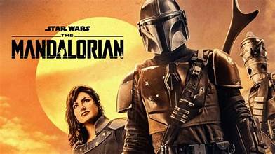 Promotional poster for 'The Mandalorian' featuring a character with armor and a weapon against an orange sky.